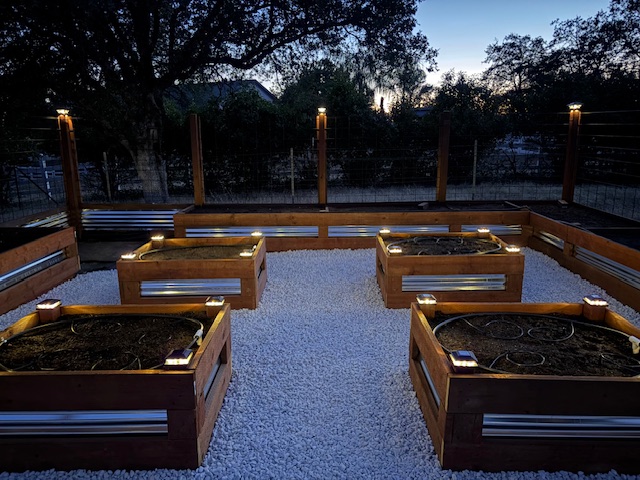 Custom garden pergola with lighting at dusk